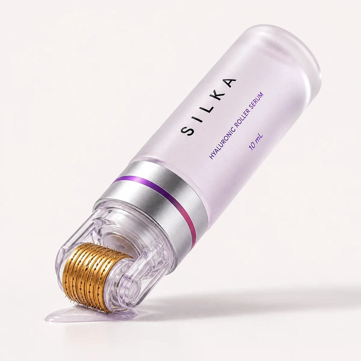 The capped Silka roller bottle lying at an angle, gold roller head visible through the clear cover
